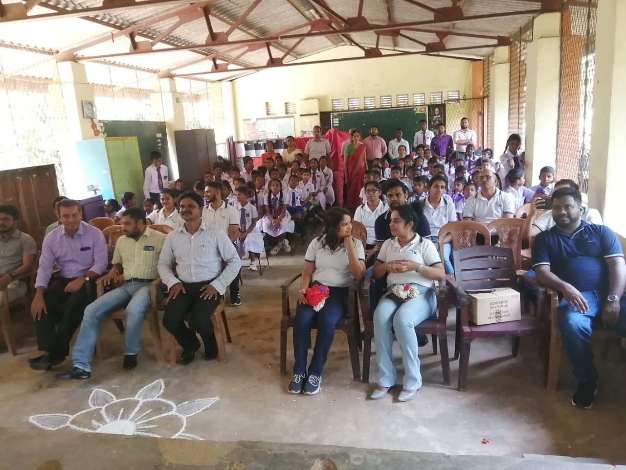 Seated school children and teachers at a school class room