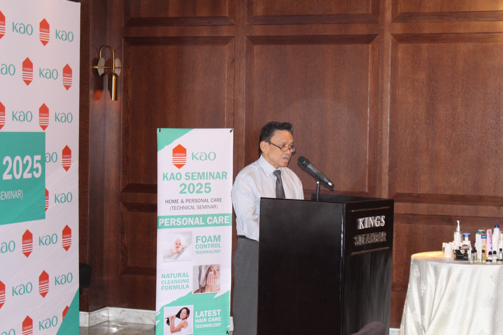 A participant conducting a speech near a podium at KAO seminar 2025